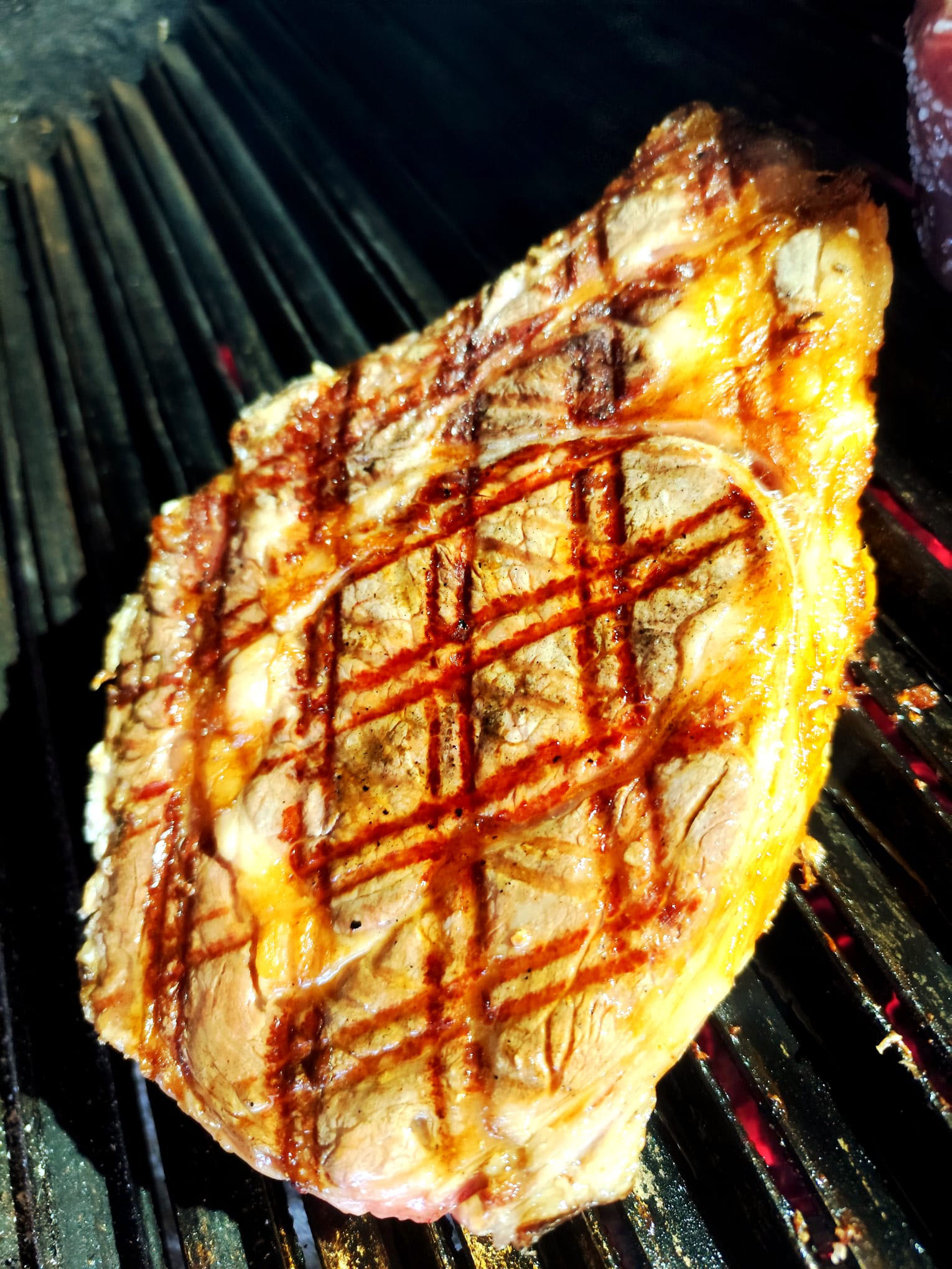 Steak searing over the Can Bestia fire